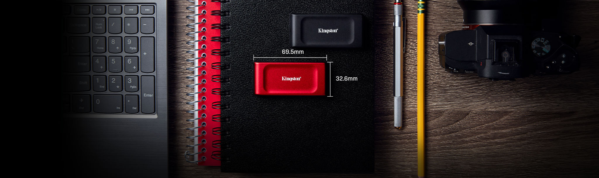 Black and red Kingston XS1000 portable SSDs on a notebook